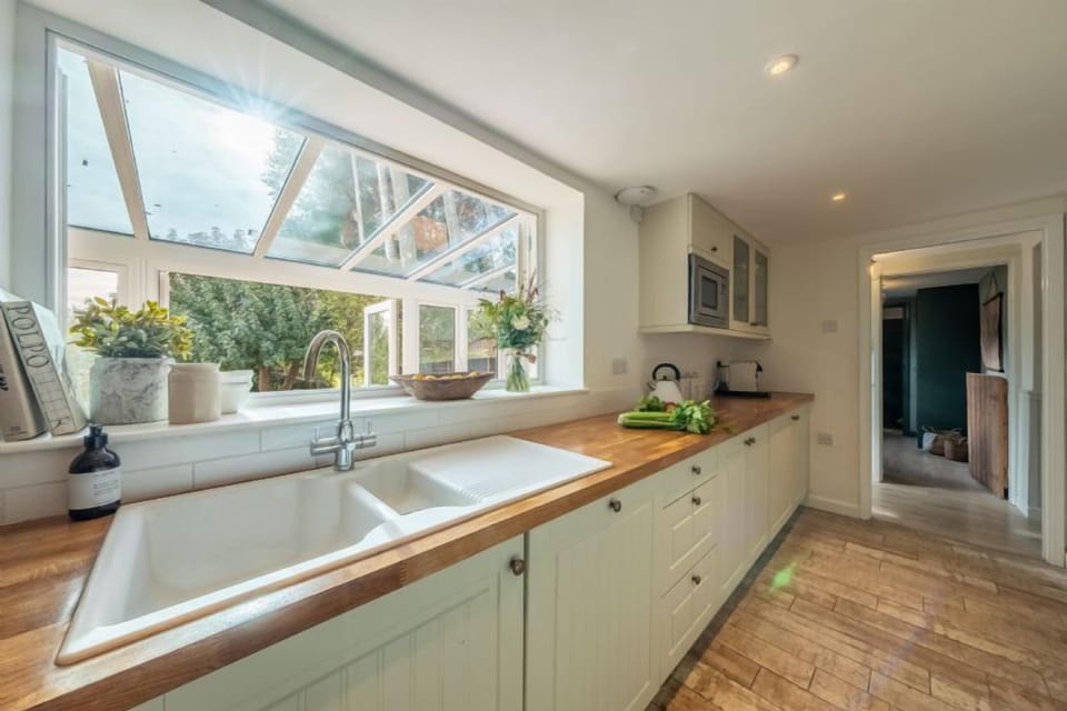 Ground floor: The kitchen has windows opening into the garden room ...