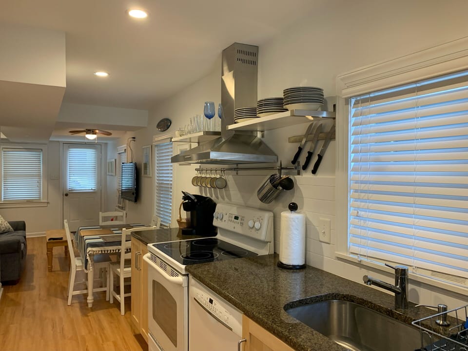 Open kitchen with granite countertops, dishwasher, microwave, garbage disposal.