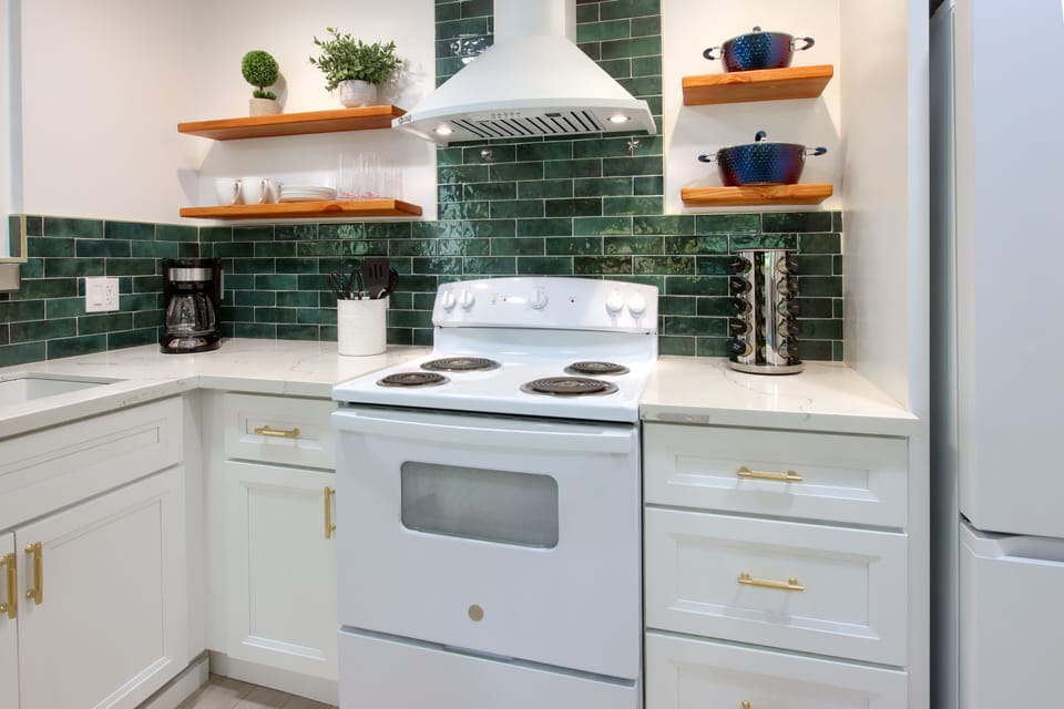 White full kitchen featuring a four-burner stove for versatile cooking.