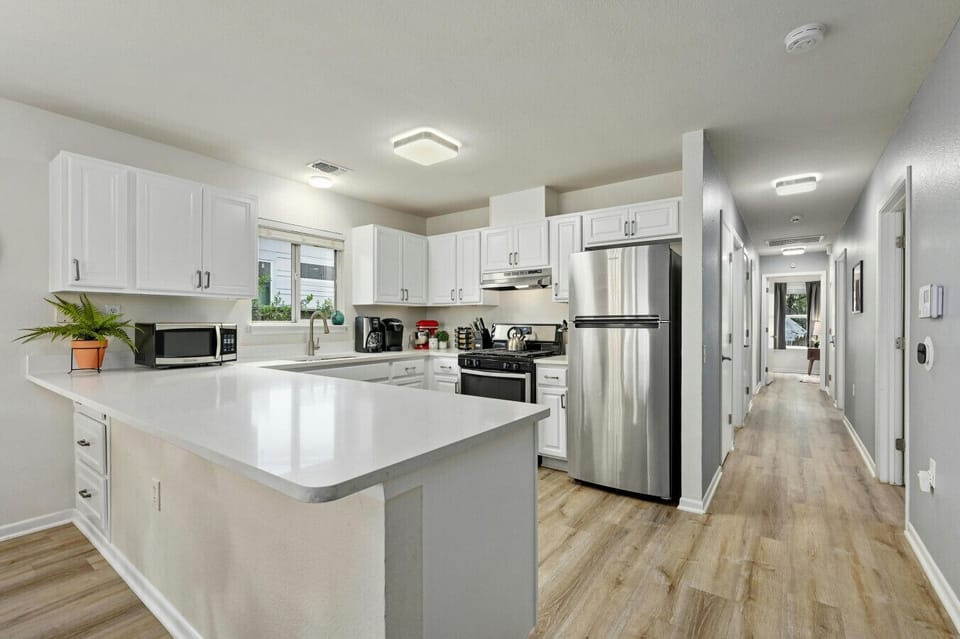 Spacious, open kitchen flows into the hallway—ideal for group stays, meal prep, and gathering after exploring East Austin.