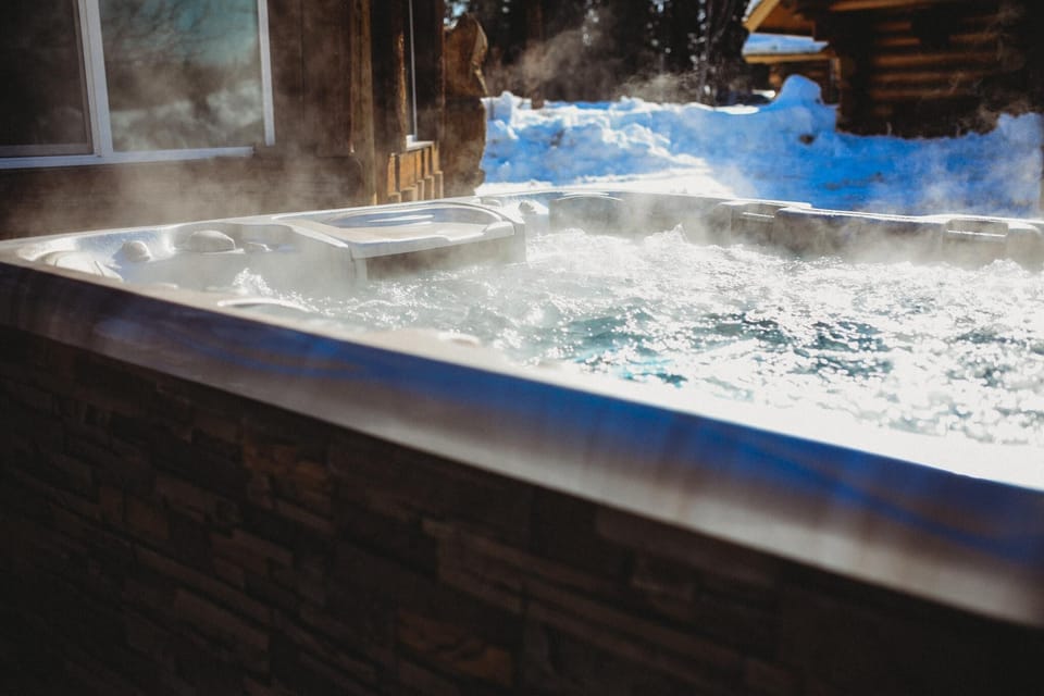 Unwind in shared hot tubs with stunning views of the snowy landscape and Northern Lights.