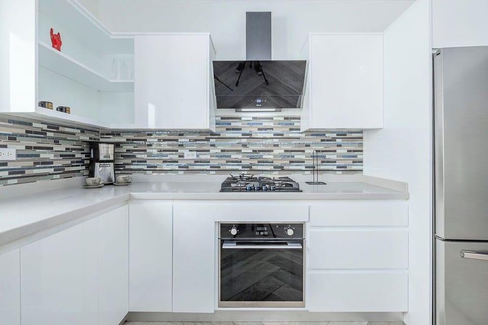 From the sleek gas stove to the crisp white cabinets, this kitchen makes cooking on holiday a total breeze.