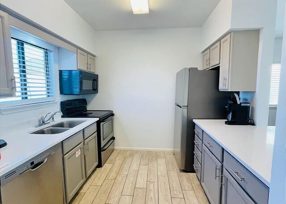 Your fully equipped kitchen awaits with stainless appliances, bright counters, and everything needed for home-cooked meals during your stay.