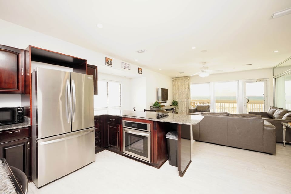 Spacious kitchen with granite countertops flows seamlessly into your comfortable living room, creating perfect space for cooking and relaxation.