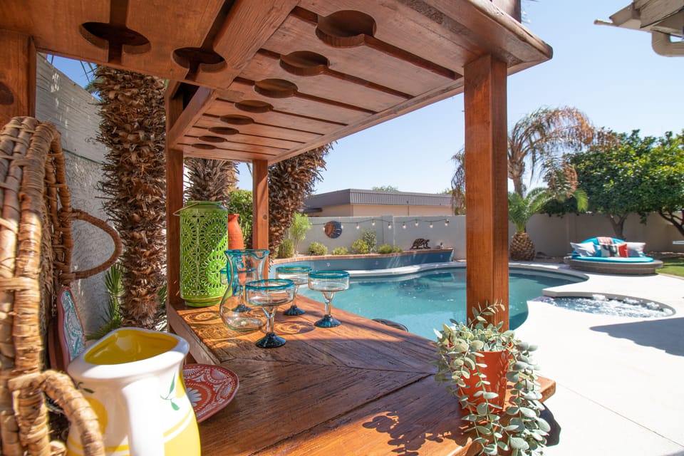 Delightful outdoor space  -  great pool, spa, grass covered yard, & custom bar!