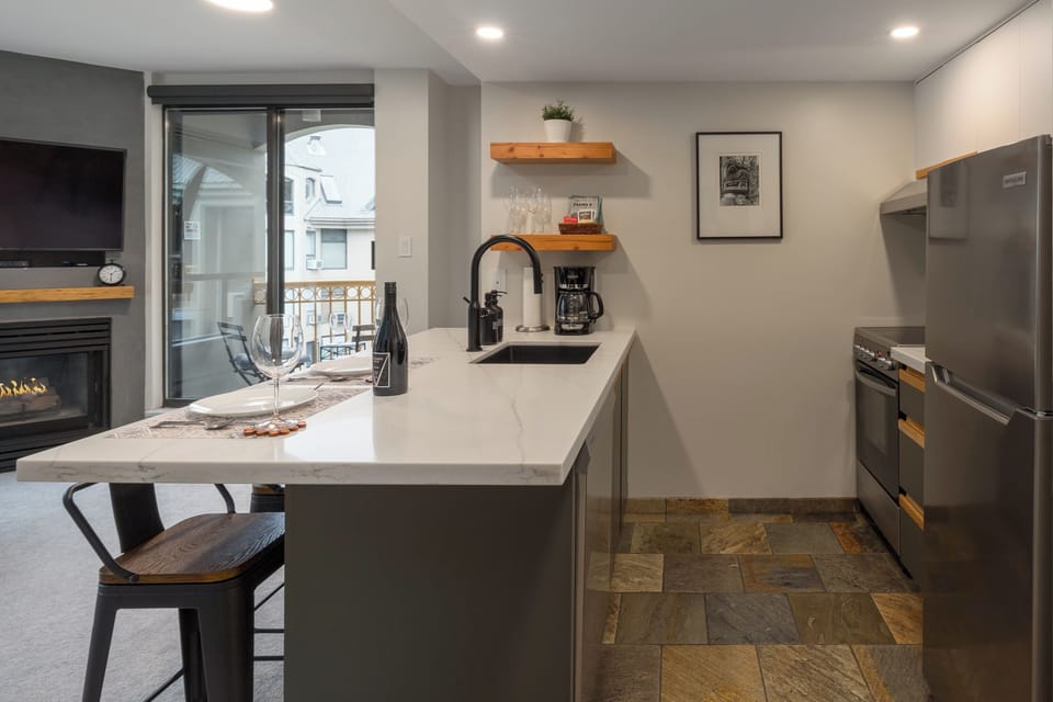 Kitchen/dining room - Four bar stools perfect for casual dining, open kitchen fully equipped for home cooking, patio for two to enjoy a morning coffee or after-ski beer.
