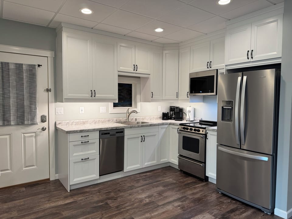 Fully equipped kitchen, with plenty of pots, pans, utensils, and dishes.