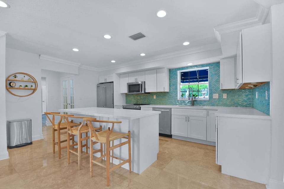 Open plan kitchen with modern fittings and utensils provided.