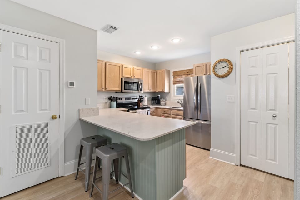 Kitchen with counter seating and stainless appliances