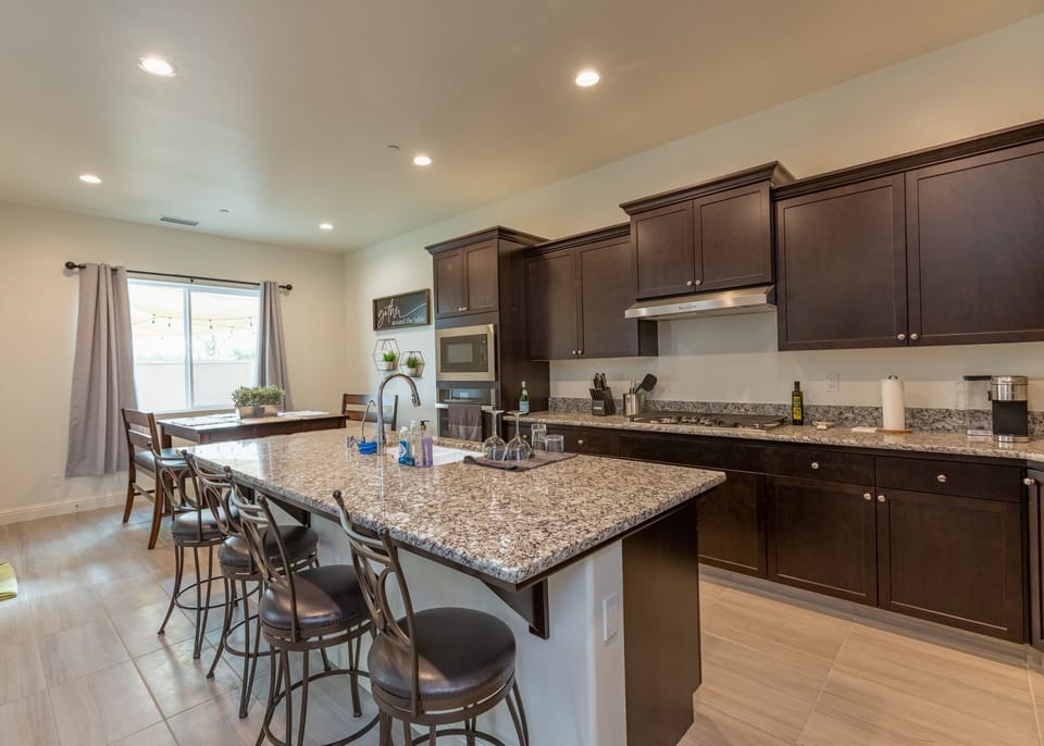 Modern kitchen with full amenities and large island for cooking or gathering.