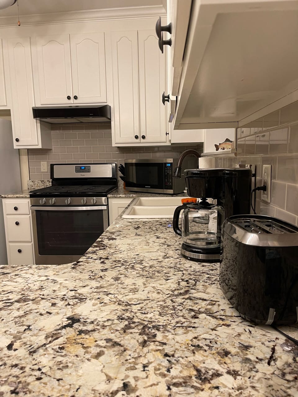 Kitchen is well stocked with utensils, plates, amenities, appliances to use