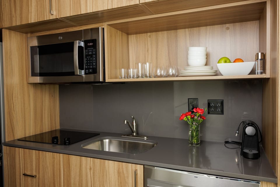 In the kitchenette, you find functionality and design hand in hand. There is a two-burner stovetop (no oven), microwave, fridge/freezer, and dishwasher. You’ll have all the utensils, pots and pans, and other equipment to make meals.