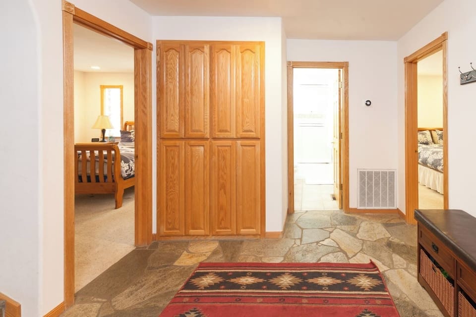 Bottom floor landing between gameroom/kids bunk Room, laundry room, bathroom and two queen bedrooms.