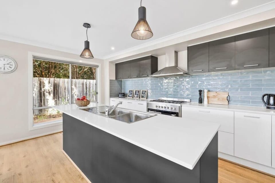 A fully equipped kitchen with quality appliances, including a large island bench