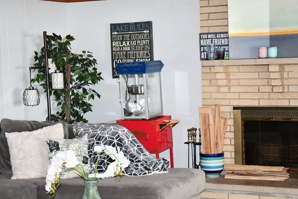 Main living room area with wood-burning fireplace & popcorn machine.