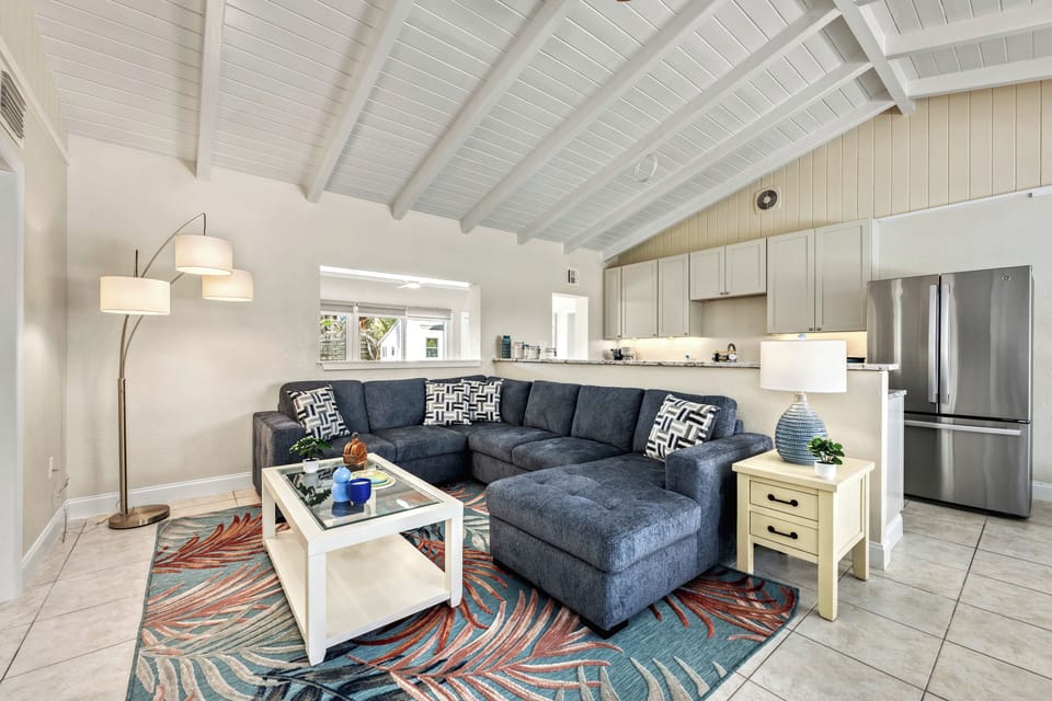 Living room with kitchen behind.
