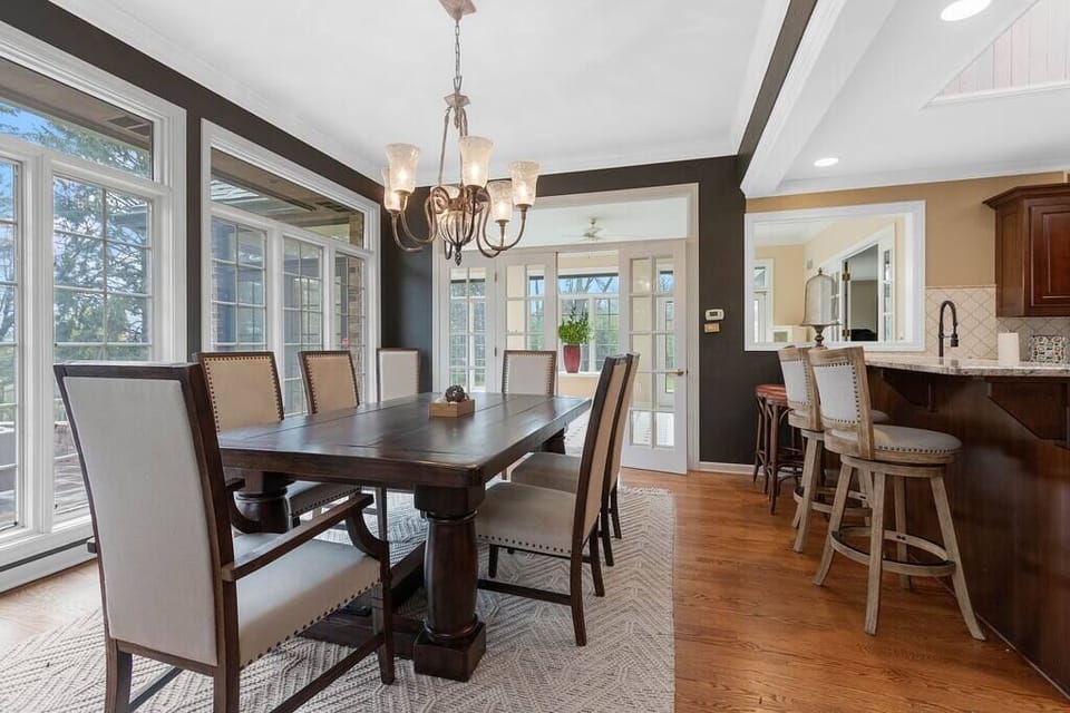 8 person dining table and four bar height stools overlook the back patio.  
