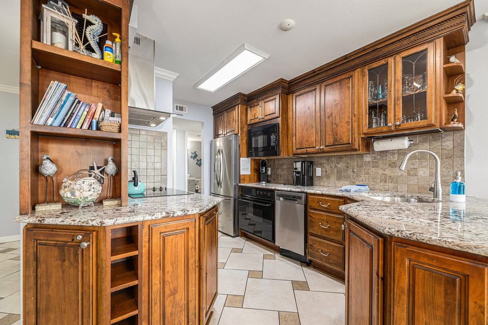 Updated kitchen with sleek granite counter tops and ample space.
