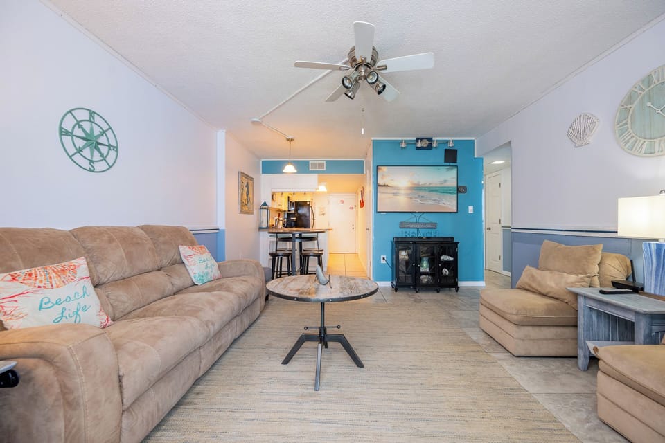 Sink into the plush couch and enjoy a cozy movie night with the family, highlighted by beach decor