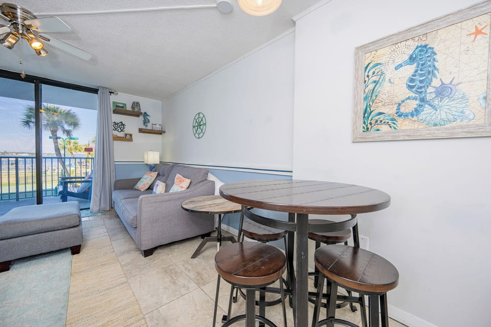 Unwind on your comfortable couch, and soak in the vibrant coastal vibe streaming through the large windows