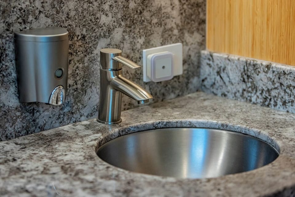 S.S. sinks and Hansgrohe faucets with neat and clean natural soap dispensers.
