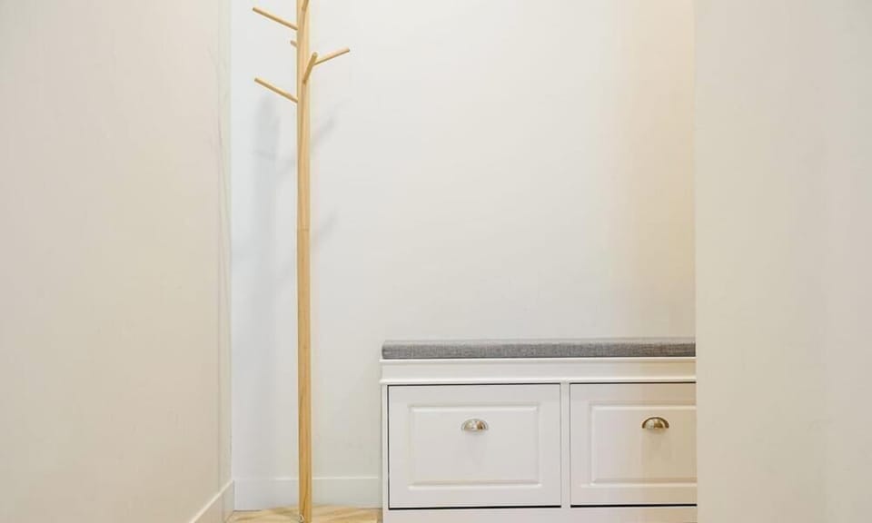 Entry area with storage drawers and coat stand.