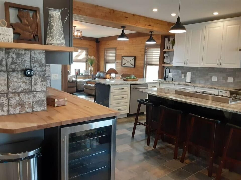 The kitchen includes a bar fridge with complimentary chilled water.