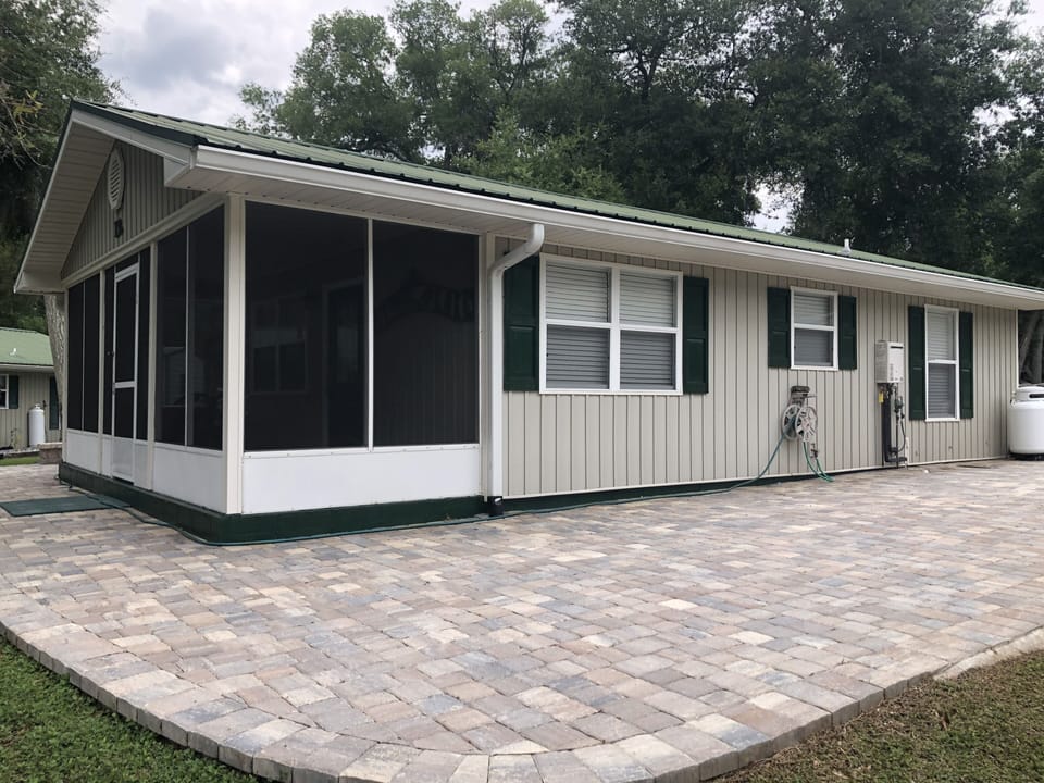 The cabin is surrounded by a beautiful and expansive stone patio
