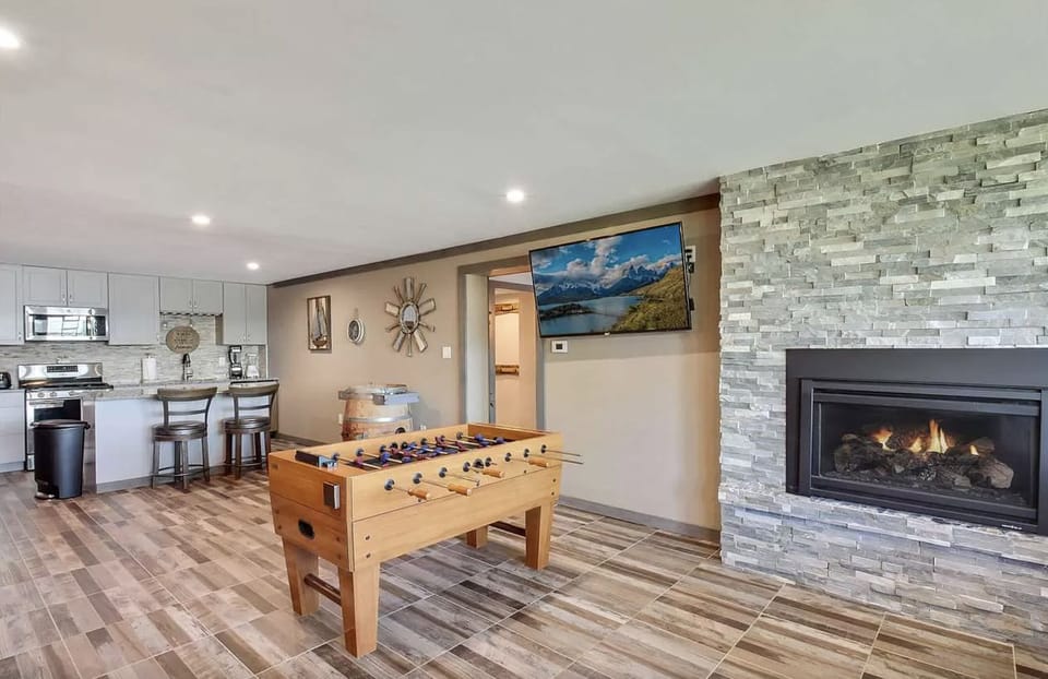 Game room includes gas fireplace and large flat screen with Hulu.
