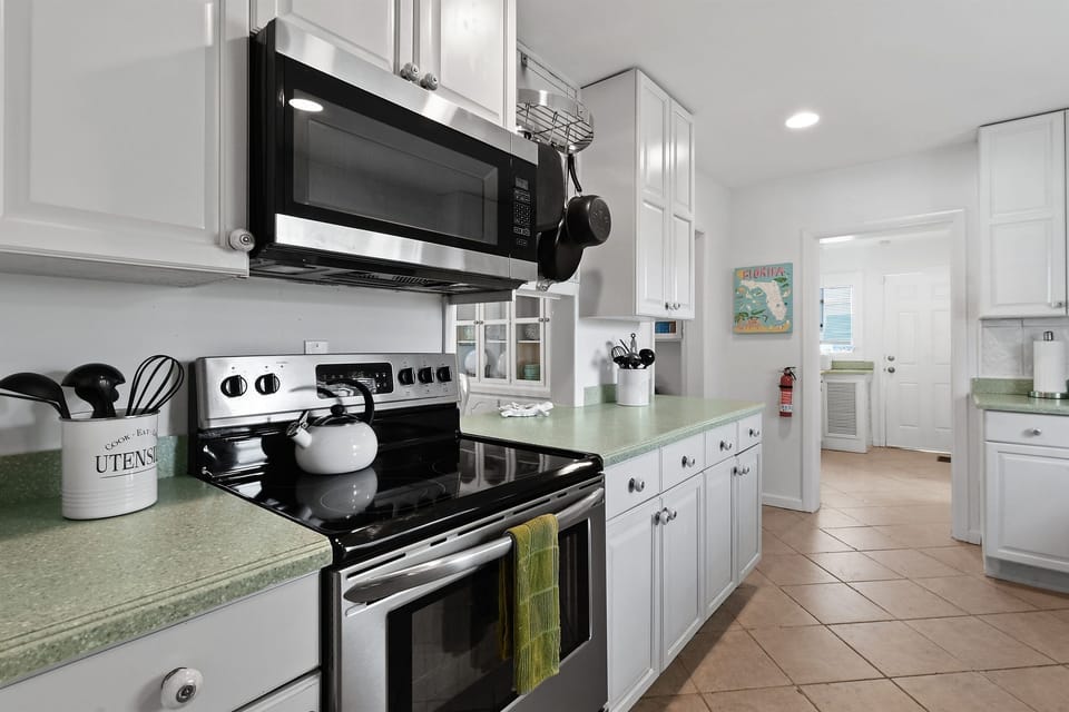 Kitchen: Well-equipped with indoor and outdoor dining sets, appliances, and utensils.