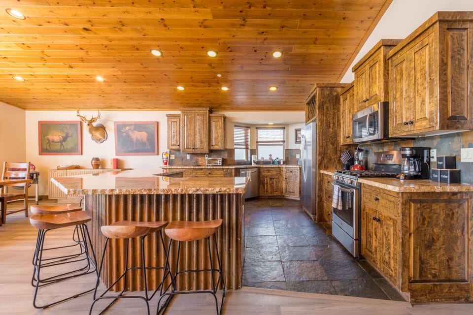 Chef's kitchen with a large island and a gas range.