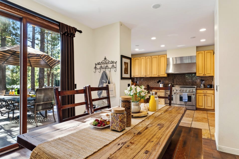 Rustic dining flows into the spacious kitchen and out to the patio for effortless group meals.