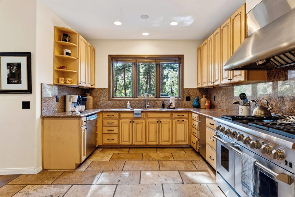 A generous kitchen with a professional-style range and ample cabinetry makes group cooking easy.