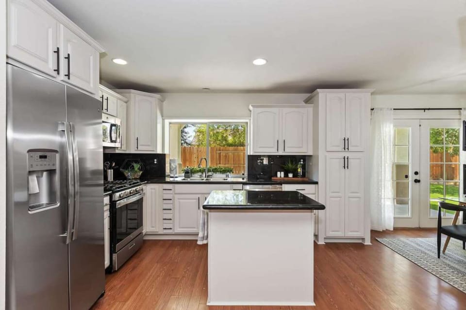 The kitchen features an island and modern appliances.