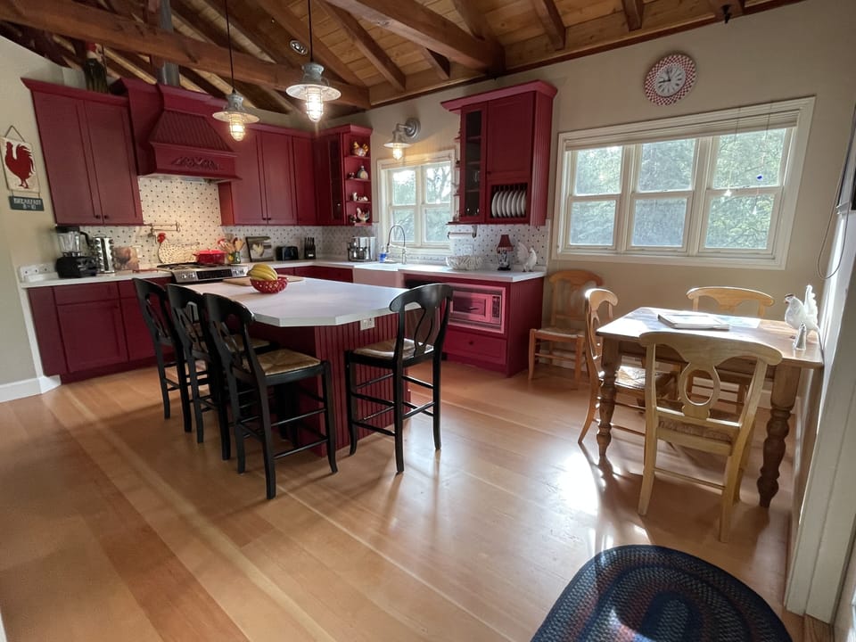 Kitchen and dining area, hardwood floors throughout unit.