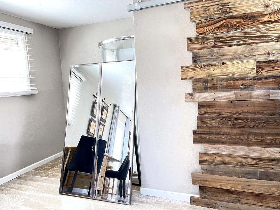 A large mirror doubles as a shower screen.