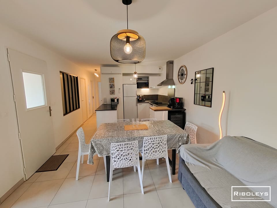 Kitchen opening onto living room with television