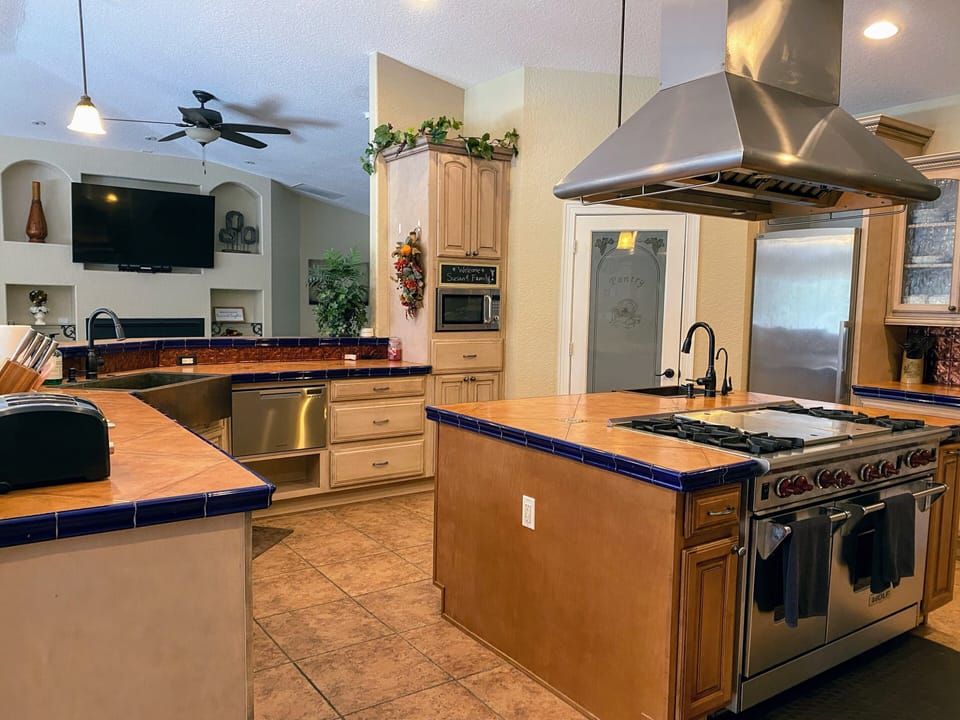 Chef’s kitchen w/2 refrigerators, dish washers,sinks,commercial hood &Wolf range