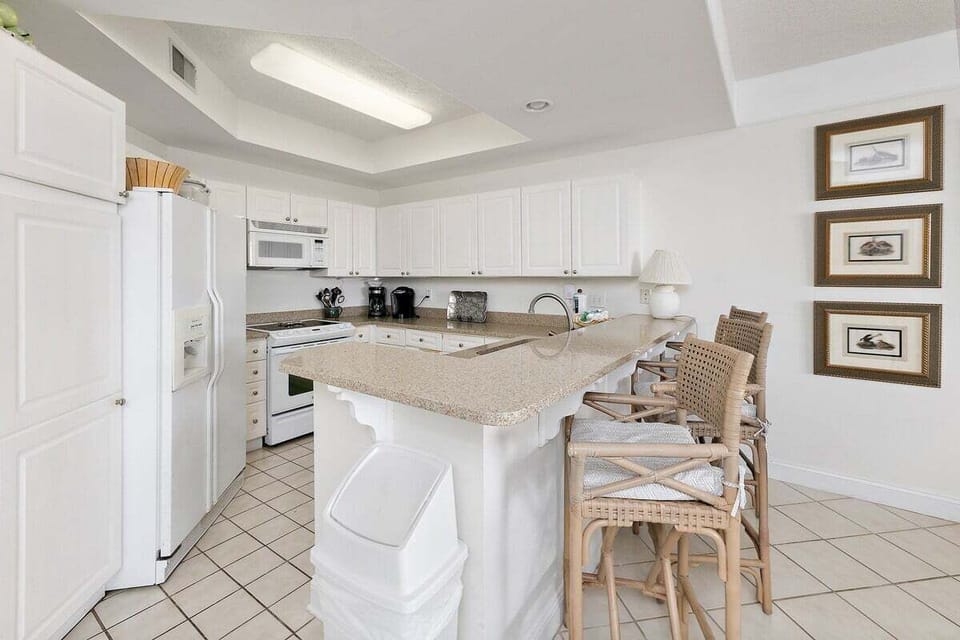 Saint Simons Grand #106 Kitchen with French Door Refrigerator, Electric Stove, and Over-the-Range Microwave