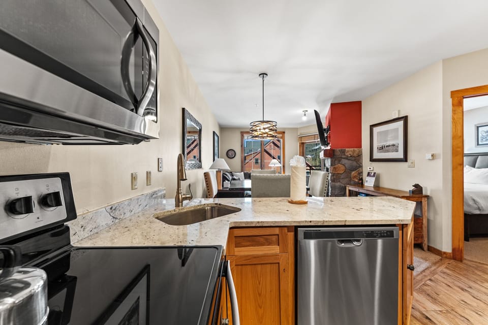 Your fully equipped kitchen features granite counters and stainless appliances, perfect for preparing meals after mountain adventures.