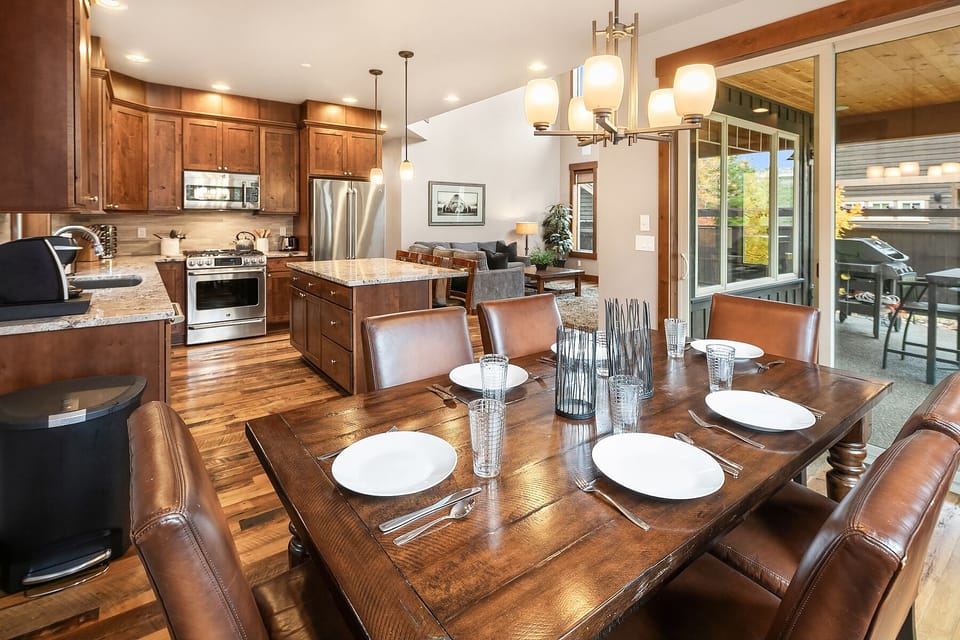 Latitude Adjustment: - Dining table just off the kitchen. Glass doors lead to the covered outdoor dining area.