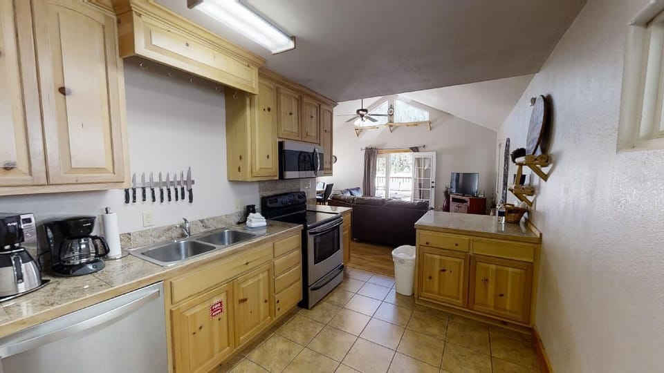 Your fully equipped kitchen flows into a cozy living space where you can gather, cook, and unwind in warm, welcoming comfort after exploring the surrounding area.