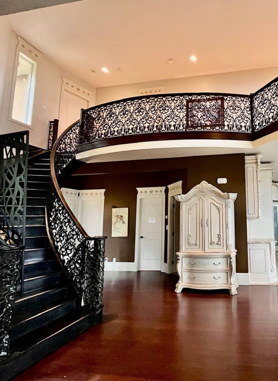 Custom Built balcony and curved stairs main floor