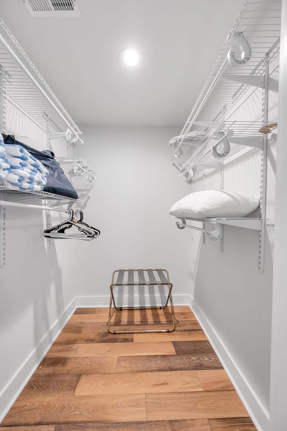 Spacious master closet offering plenty of storage and organization. Designed with convenience in mind, featuring ample shelving and hanging space to keep your belongings neatly arranged.