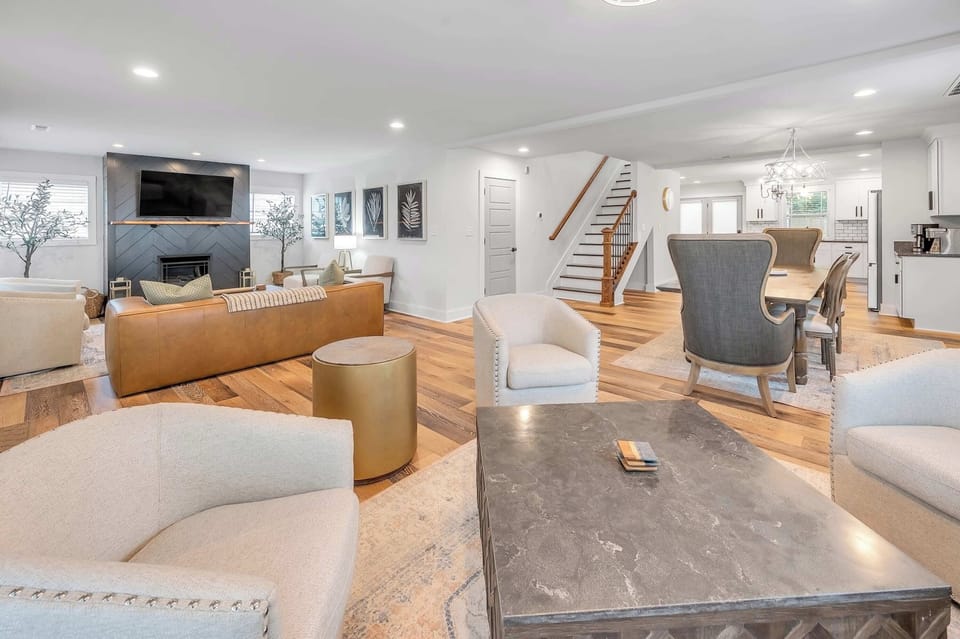 Settle
in across from
the fireplace
with the
botanical
gallery wall
behind you —
grab the gold
accent stool if
the sectional's
already full.