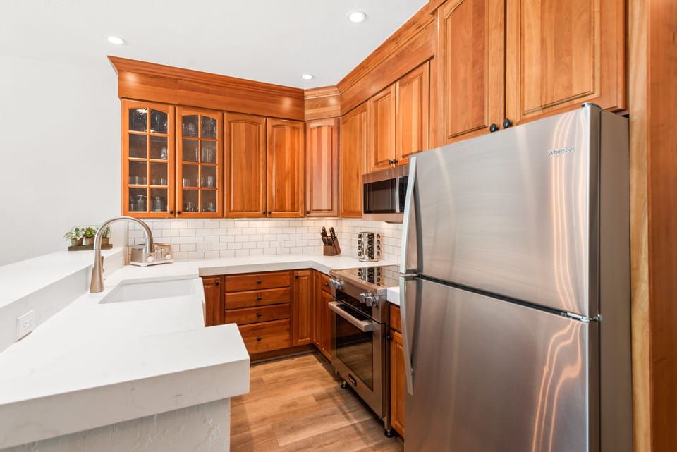 Newly upgraded kitchen with Kohler farmhouse sink, Miele induction range