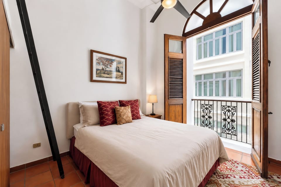 Bright second bedroom with a Queen bed, Juliette balcony & A/C.