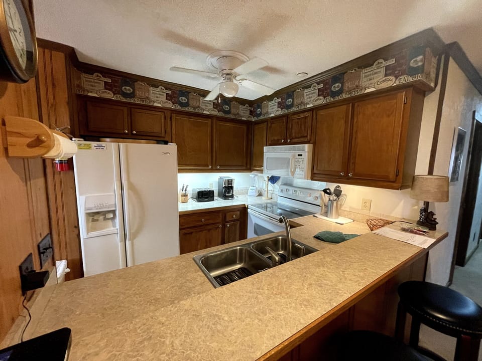 Galley Kitchen with Bar and High Top Stools