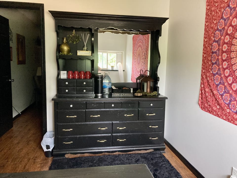 Keurig and coffee fixings. Kids books are in the bottom drawer