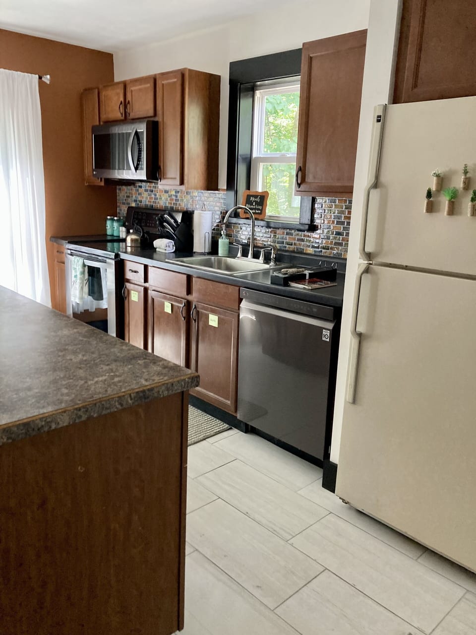 Kitchen with microwave, range, dishwasher, fridge, coffee bar, and a view! 